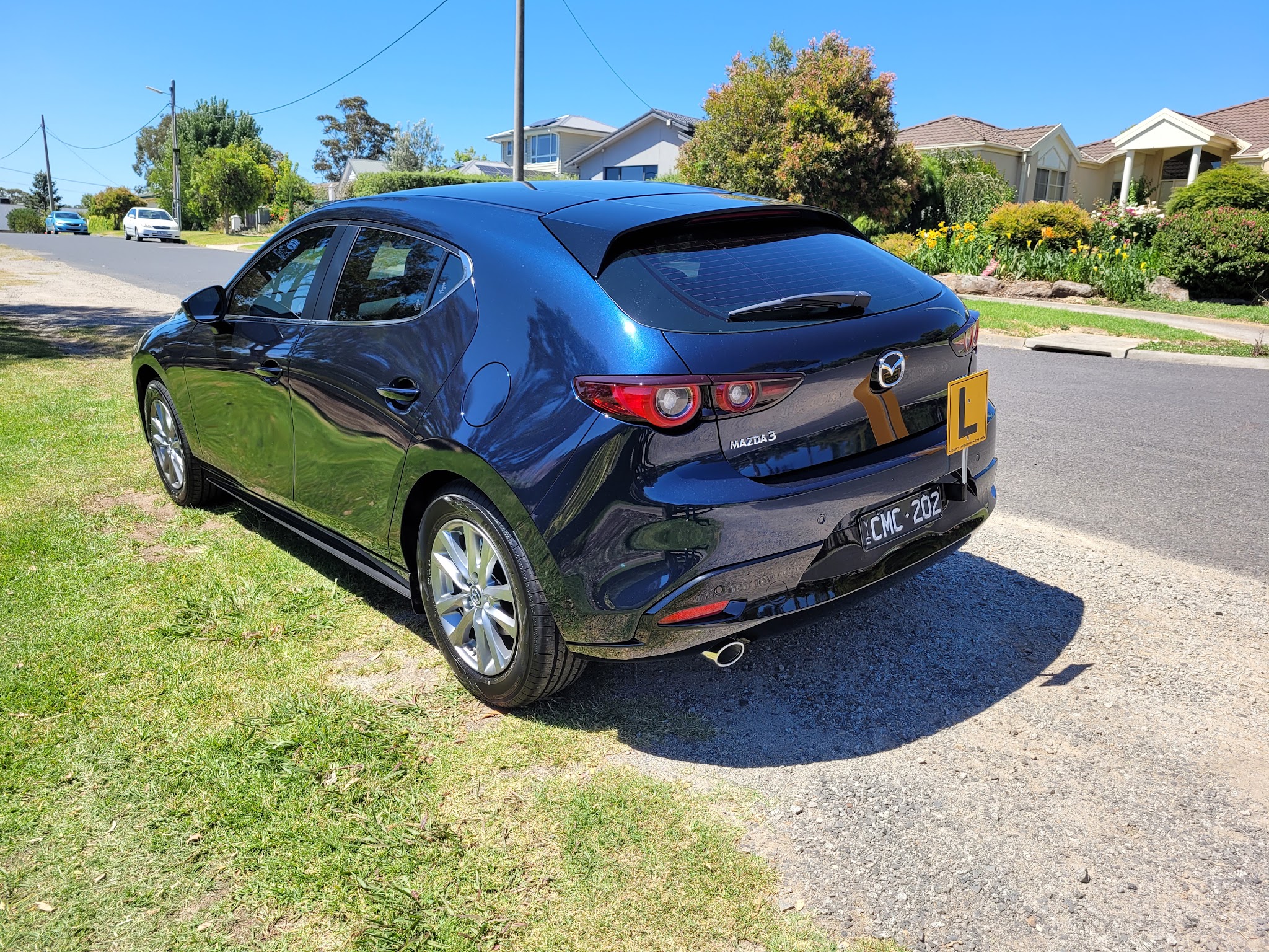 Rear three-quarter view of the Mazda 3 learner car on a Sunbury street