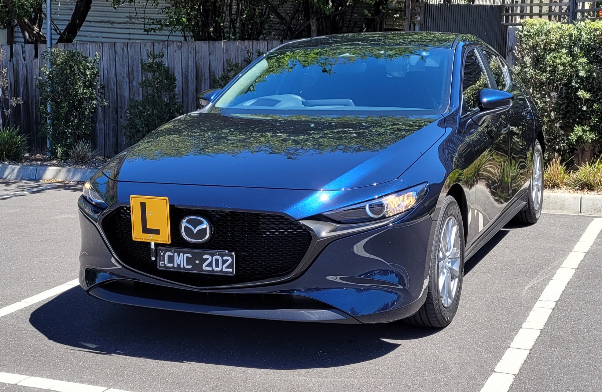 The Mazda 3 learner car parked in a marked car park bay